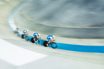 Track cycling team racing in velodrome