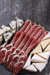 photo sausage and cheese slices on a dark background