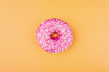 Pink donut on color background, flat lay, top view