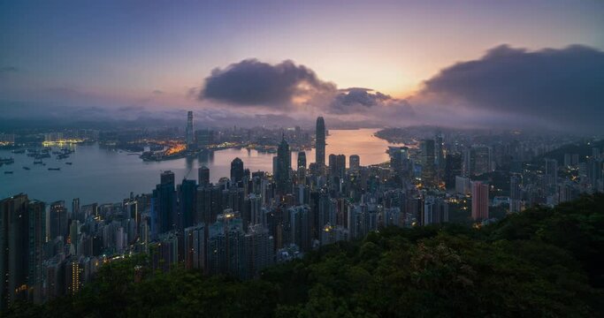 4K Timelapse night to sunrise aerial view of Hongkong city skyline view form Victoria peak , China 
