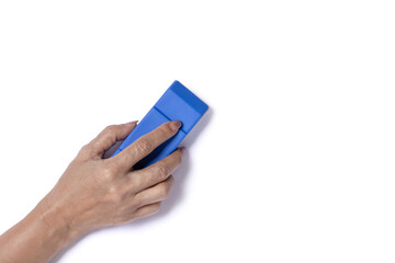 Hand holding and using brush eraser isolated on white background. Top view, flat lay.