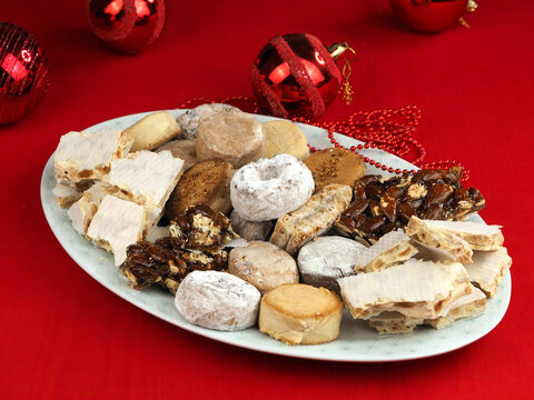 Plate with different typical Christmas sweets of Spain: turrones, estepa, mantecados, polvorones