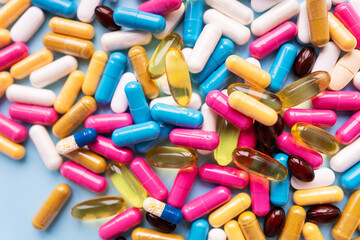 Lots of colorful pills and capsules for different symptoms. Concept of health and medicine.
