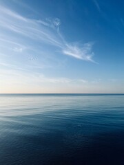 Obraz premium Blue sea horizon with some light clouds, seascape background