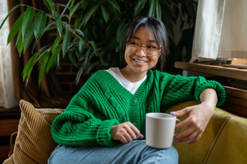 Smiling asian young girl having morning tea