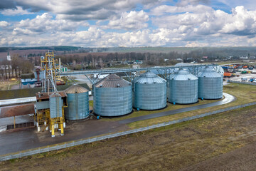 aerial panoramic view on agro-industrial complex with silos and grain drying line for drying cleaning and storage of cereal crops