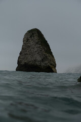 Beautiful picture of sea waves with large rocks at the distance