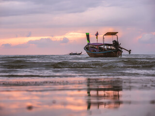 Sunset over traditional Thai boat, Krabi, Thailand