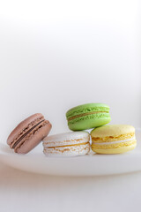 Multicolored macaroons. Two halves. Delicate French cookies. Coffee dessert. Cookies based on meringue. Crunchy crust. Colorful macaroon cookies in an appetizing still life.