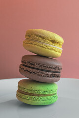 Multicolored macaroons. Two halves. Delicate French cookies. Coffee dessert. Cookies based on meringue. Crunchy crust. Colorful macaroon cookies in an appetizing still life.