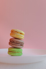 Multicolored macaroons. Two halves. Delicate French cookies. Coffee dessert. Cookies based on meringue. Crunchy crust. Colorful macaroon cookies in an appetizing still life.