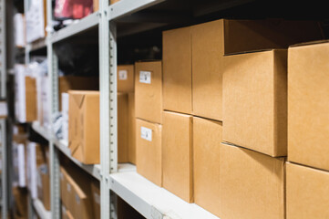 Cardboard boxes lie on racks in a small warehouse. Logistics transportation and delivery of goods