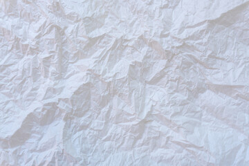 Wrinkled or crumpled white stencil paper or tissue after use in toilet or restroom with large copy space used for background texture in decorative art work