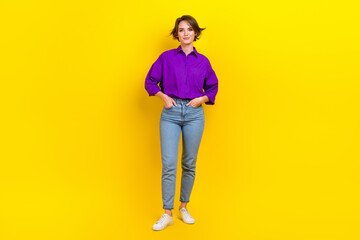 Full size photo of pretty young girl hand pockets posing dressed stylish purple smart casual outfit isolated on yellow color background