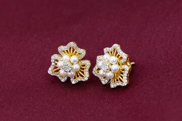 Fototapeta na wymiar Gold stud earrings with Pearls