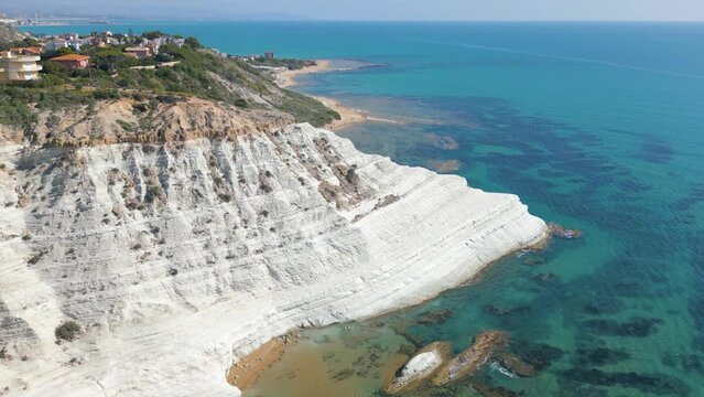 This aerial drone video shows the beautiful coastline of the Turkish Stairs, also named Scala dei Turchi. This natural wonder can be found at the coast of Sicily, southern Italy.