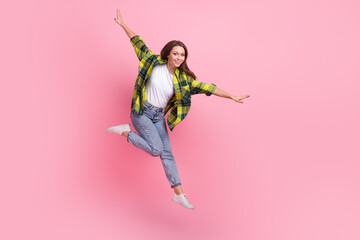 Full size portrait of overjoyed pretty girl jumping flying have good mood isolated on pink color...