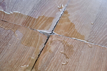 Close-up a wooden laminate in an apartment or house damaged by spilled water