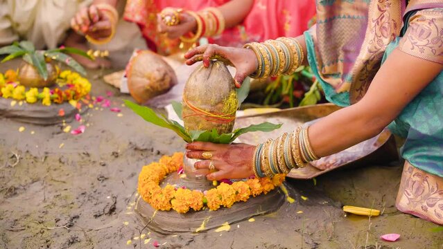 Indian woman preparing coconut for Pooja