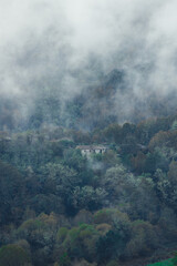 house in the fog in the mountains