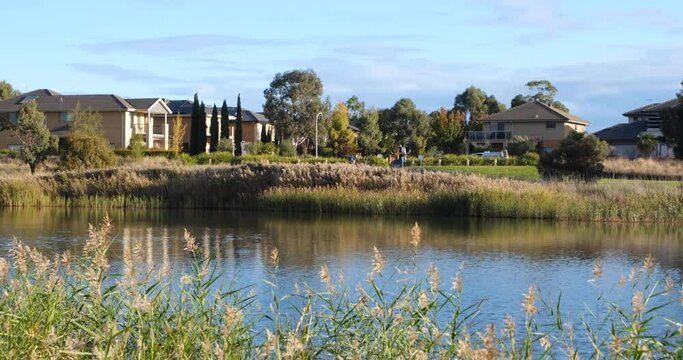 Beautiful scenery of wetlands at skeleton creek near Melbourne’s residential suburban neighbourhood.  Luxury waterfront houses in the distance. Point Cook VIC Australia.