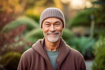 Naklejka na ściany i meble Medium shot portrait photography of a satisfied mature boy wearing a warm beanie or knit hat against a serene zen garden background. With generative AI technology