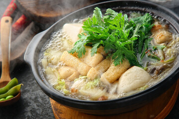 There's a crown daisy on top and it's boiling fish cake soup