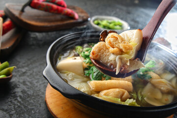 There's a crown daisy on top and it's boiling fish cake soup