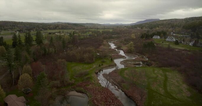 Drone 4K aerial shot flying over Little River in Stowe Vermont