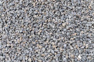 Grey granite gravel background for mix concrete. Crushed stone as a background. Construction rock.