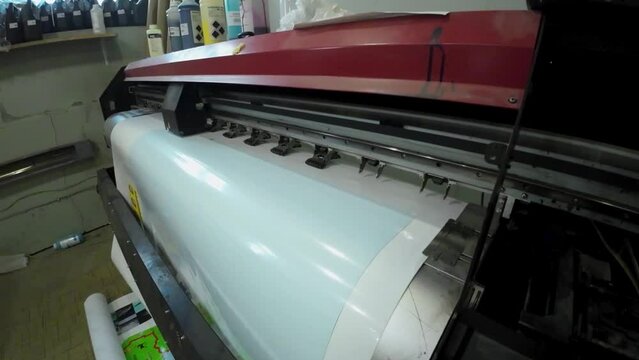 Printing machine in printing house printing images on sticky film