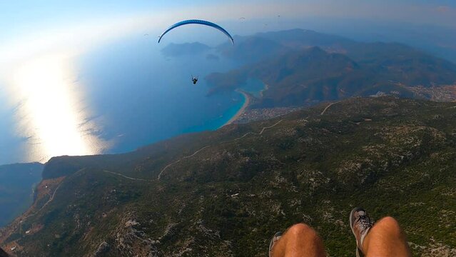 paragliding point of view flying over Oludeniz. paraglider flying away in the blue sky On the Sunset. Extreme and active types of recreation. panoramic view from the gopro. High quality FullHD footage
