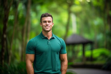 Medium shot portrait photography of a satisfied boy in his 30s wearing a sporty polo shirt against a lush tropical jungle background. With generative AI technology