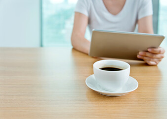 Woman using her tablet pc in cafe