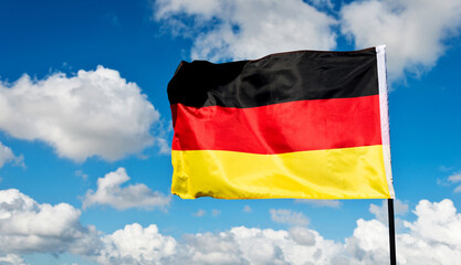 German flag waving against blue sky