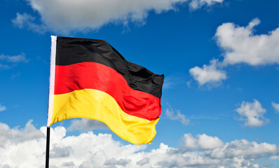 German flag waving against blue sky