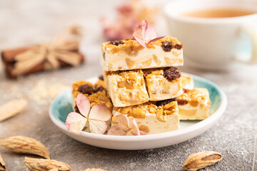 Traditional candy nougat with nuts and sesame, side view, selective focus.