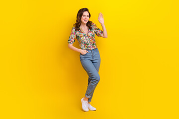 Full size photo of adorable sweet lady standing posing waving hand saying hello to her friends isolated vibrant color background - obrazy, fototapety, plakaty