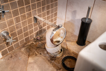 Repairing of the current old toilet bowl at work in bathroom, plumbing repair service, cleaning,...