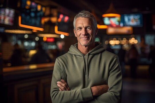 Medium shot portrait photography of a glad mature man wearing soft sweatpants against a lively sports bar background. With generative AI technology