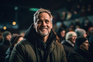 Obraz na płótnie Canvas Medium shot portrait photography of a satisfied mature man wearing a comfortable hoodie against a lively concert venue background. With generative AI technology