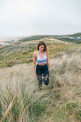 Girl in the dunes of Scheveningen in The Hague Netherlands