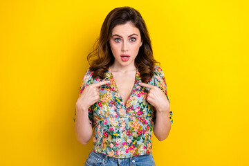 Portrait of shocked speechless questioned girl point fingers self herself isolated on yellow color background