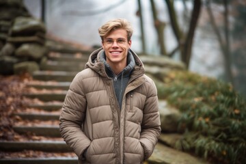 Lifestyle portrait photography of a happy boy in his 30s wearing a cozy winter coat against a serene rock garden background. With generative AI technology