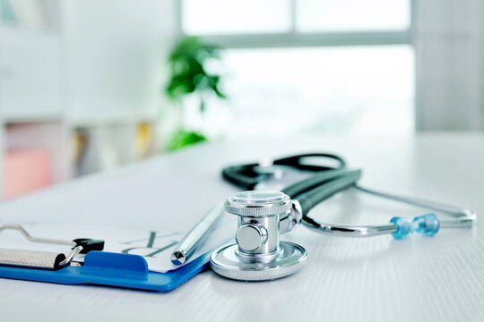 Stethoscope And Medical Clipboard  On Doctor Desk