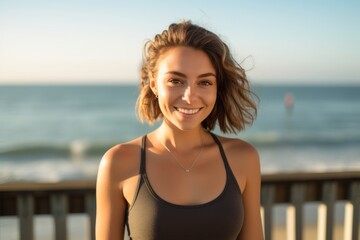 Environmental portrait photography of a glad girl in her 30s wearing a cute crop top against a scenic beach pier background. With generative AI technology