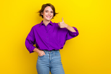 Photo portrait of pretty young girl showing thumb up dressed stylish purple smart casual outfit isolated on yellow color background