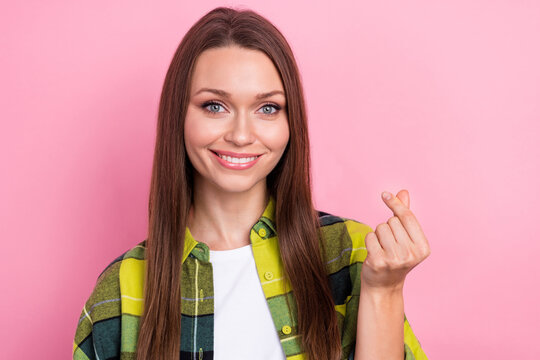 Portrait of positive adorable lady beaming smile arm fingers demonstrate korean love gesture isolated on pink color background