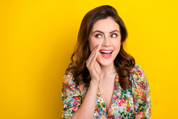 Fototapeta na wymiar Photo of cheerful gorgeous lady hand near mouth look communicate empty space isolated on yellow color background