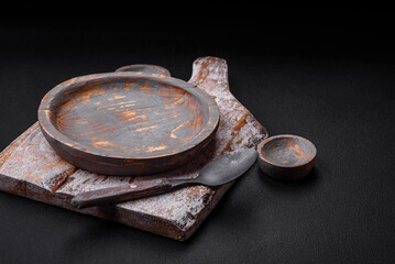 Empty wooden plate, knife, fork and cutting board